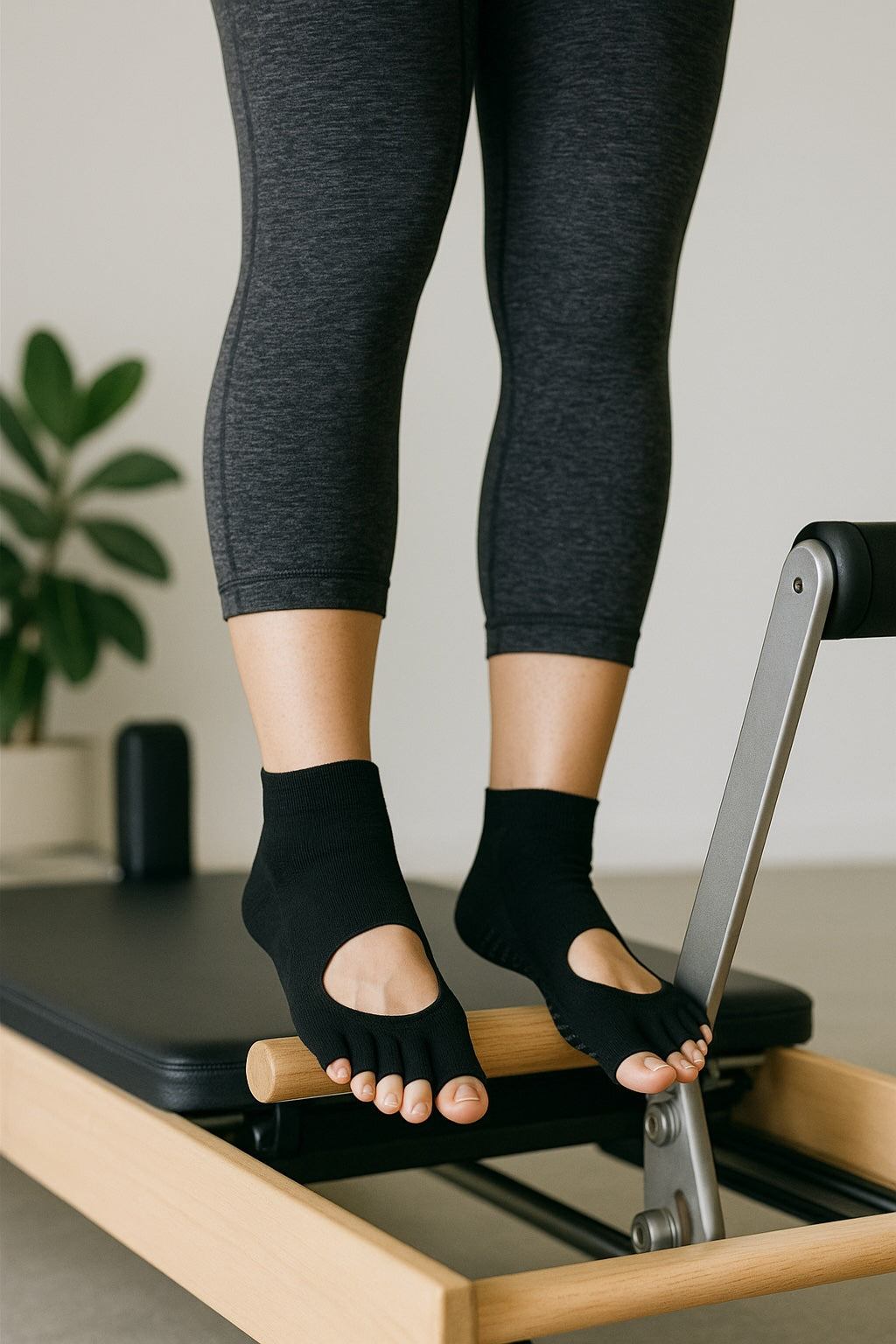 Black pilates grip socks on reformer machine 
