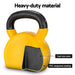 Yellow kettlebell with black handle and cast iron core, labeled 'Heavy-duty material'.