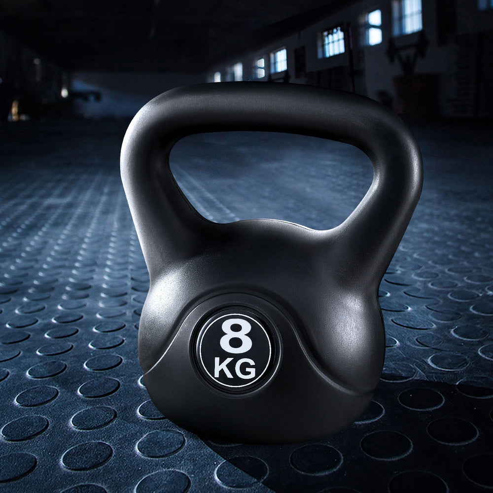 Black kettlebell with '8 KG' marking on a textured gym floor