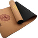 Two yoga mats, one brown and one black, with decorative symbols on a white background.