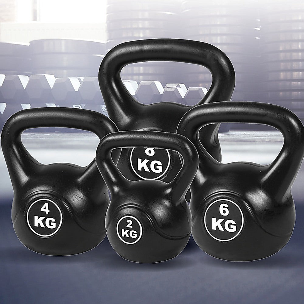 Set of black kettlebells with weight markings on a blurred background