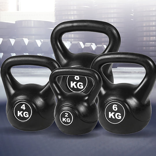 Set of black kettlebells with weight markings on a blurred background