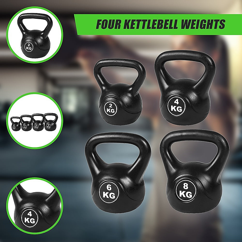 Set of four kettlebells with weights displayed on a blurred gym background