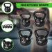 Set of four kettlebells with weights displayed on a blurred gym background